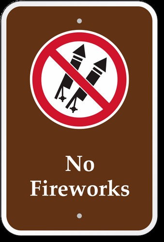 brown sign with white text that states No Fire Works with imag of crossed out fire works