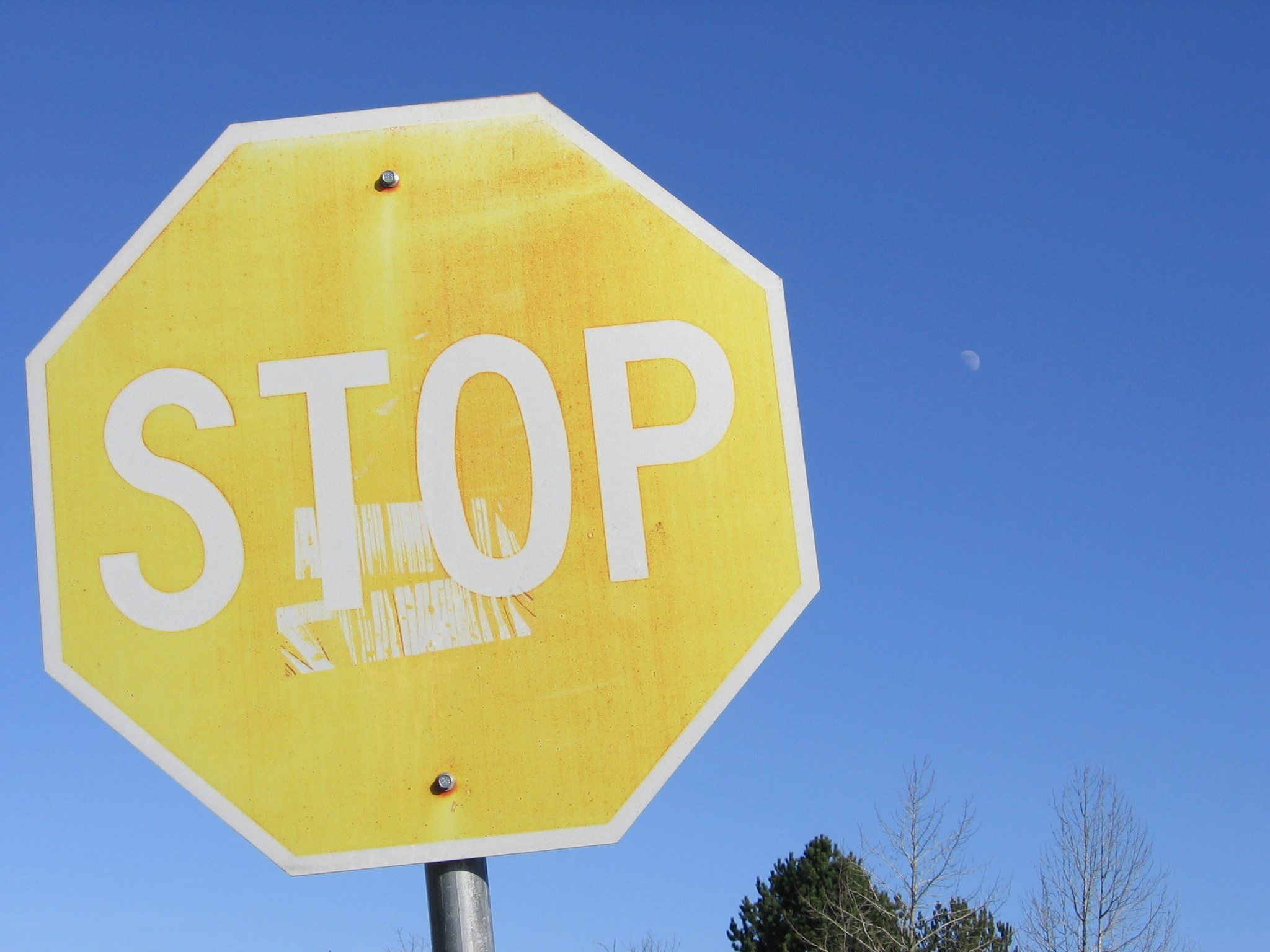 worn out and faded stop sign